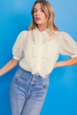 A solid woven top featuring shirt collar with pearl embellishment trim