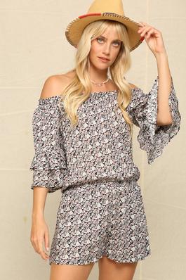 A ROMPER FEATURED IN AN OFF THE SHOULDER NECKLINE.
