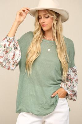 THE PULLOVER WITH CONTRAST PRINT AT SLEEVES.