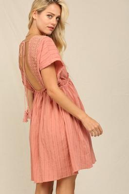 THE COVER UP STYLE SWINGY DRESS WIT TASSEL TRIM.